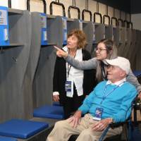 Guests looking at named lockers at the Jamie Hosford Football Center dedication.